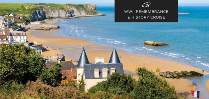 Arromanches beach in Normandy with the remains of the D-Day Mulberry harbor on a WWII remembrance river cruise