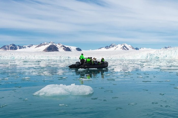 Atlas Ocean Voyages guests on a Zodiac among Arctic sea ice and glaciers