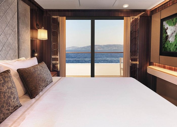 Navigator Suite bedroom with ocean views aboard Atlas World Navigator