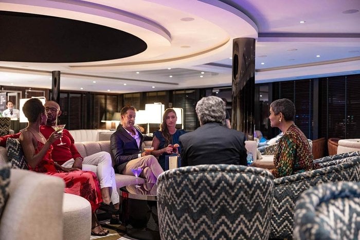 Guests enjoying cocktails in The Dome observation lounge aboard Atlas World Navigator