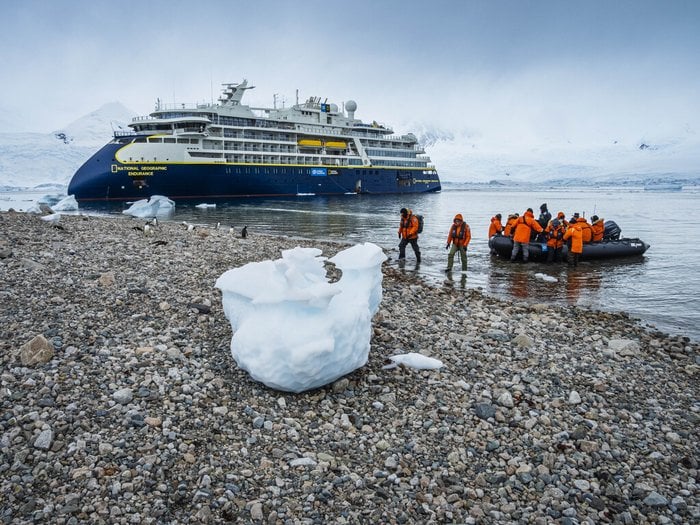 National Geographic-Lindblad Expeditions military discount guests landing by Zodiac in Antarctica