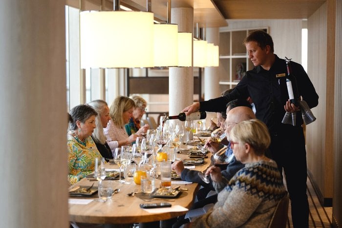 Guests dining together aboard a National Geographic-Lindblad expedition ship
