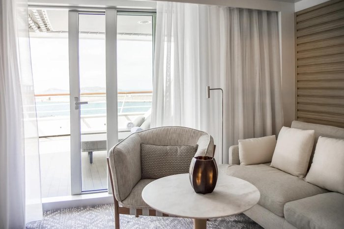 Light-filled sitting area of a PONANT Explorer-class suite with balcony