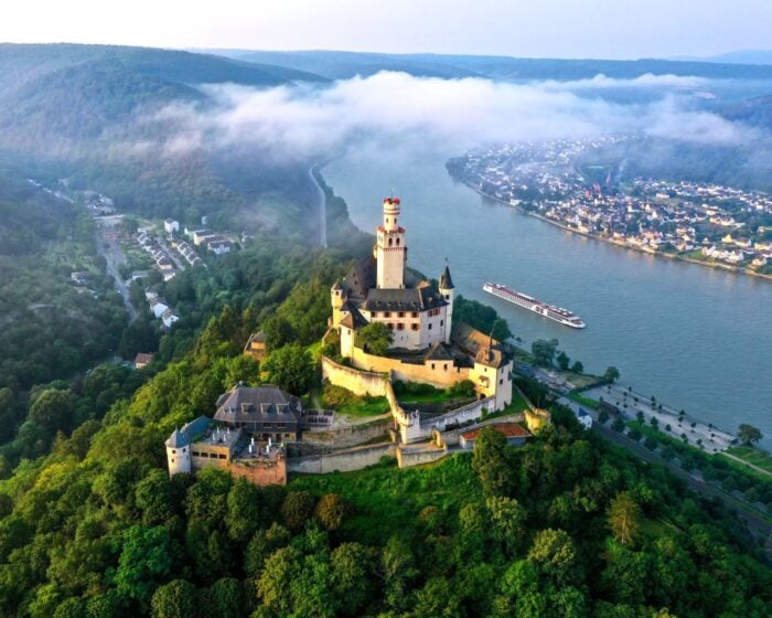 Viking Longship sailing the Rhine Gorge below Marksburg Castle on a WWII history river cruise