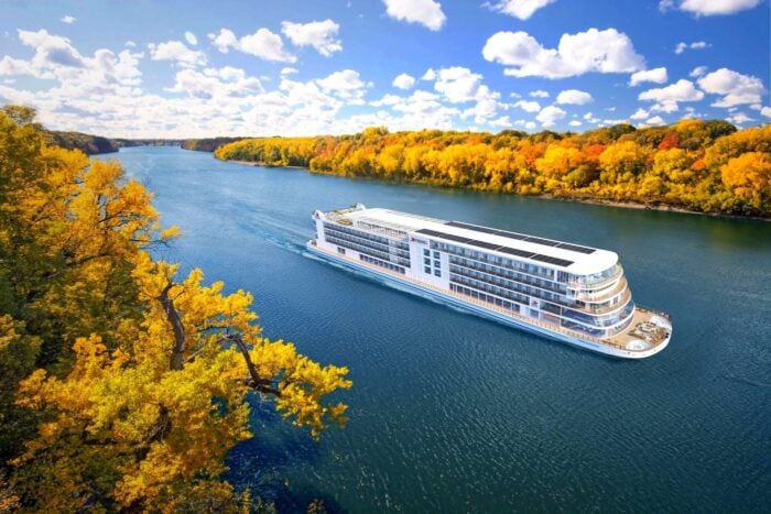 Viking Mississippi river cruise ship sailing past fall colors on the Upper Mississippi